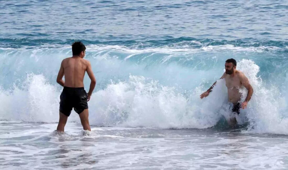 Antalya'da güneşli bir pazar günü, plajda yoğun kalabalıkla birlikte tatilin